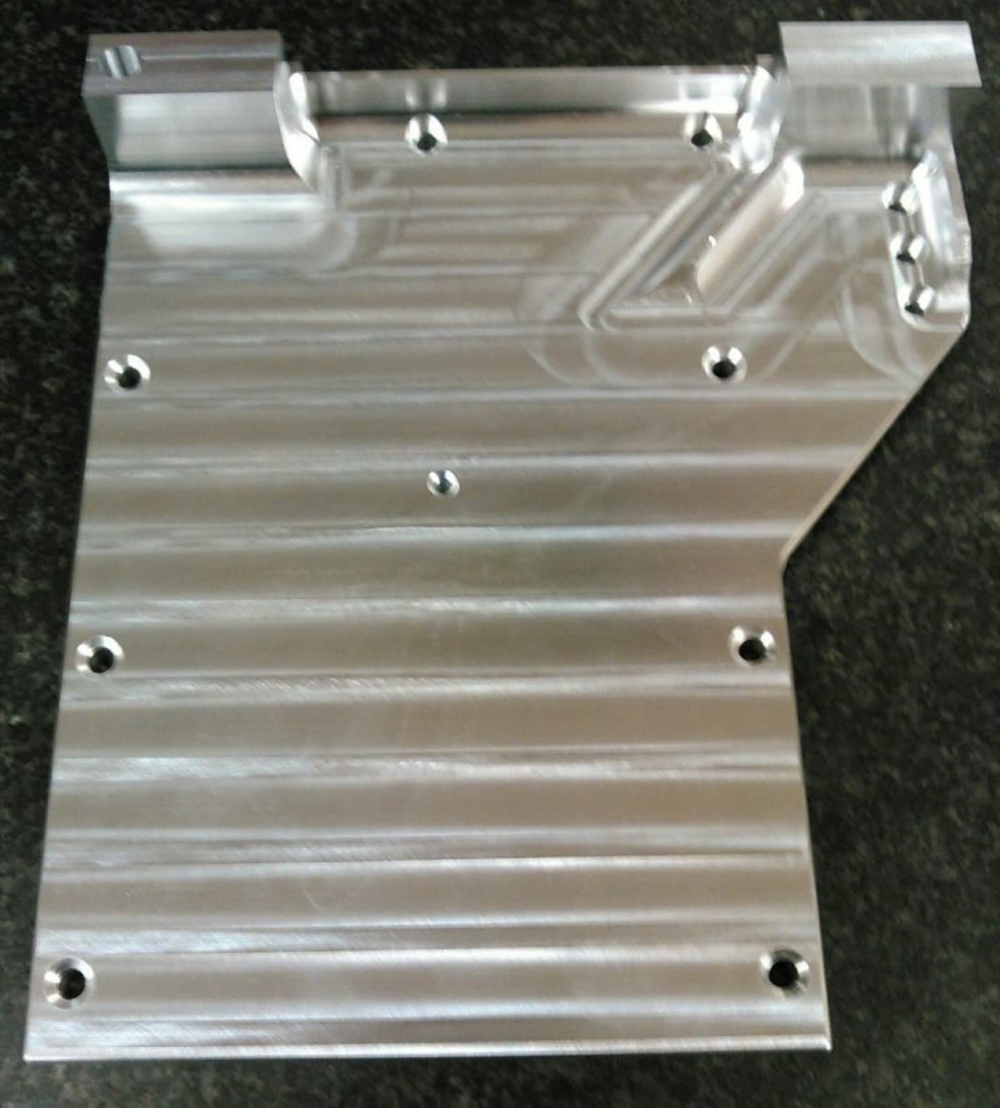 Precision-machined aluminum bracket produced by CNC Machining, Inc.